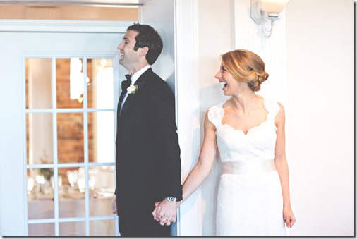 Bride and Groom behind a wall before the ceremony