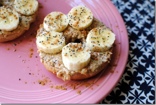 Toasted bagel topped with almond butter, cinnamon, banana and chia seeds