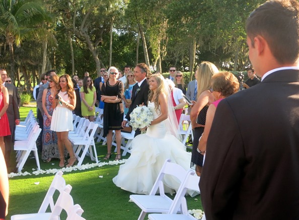 father of the bride escorting daughter